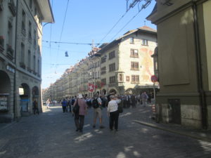 The medieval Clock Tower in Bern, Switzerland, seen from the Kramgasse. In the foreground is the Zähringen Fountain, surmounted by a bear in armour, the city's heraldic device.